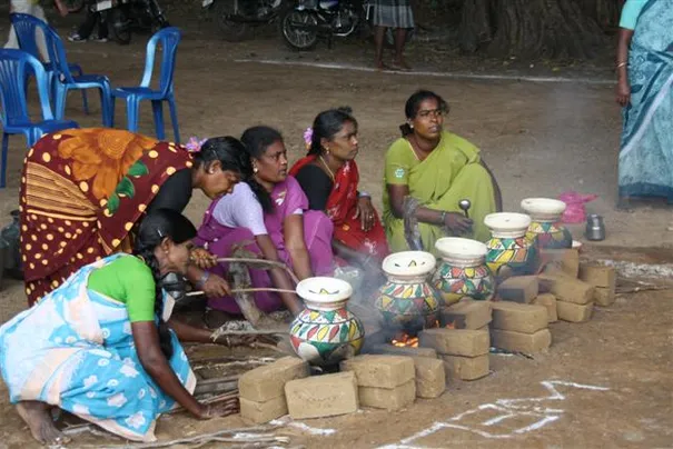 The ladies preparing the traditional food for Pongal.