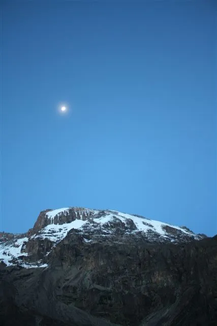 The moon rising over the summit of Kili