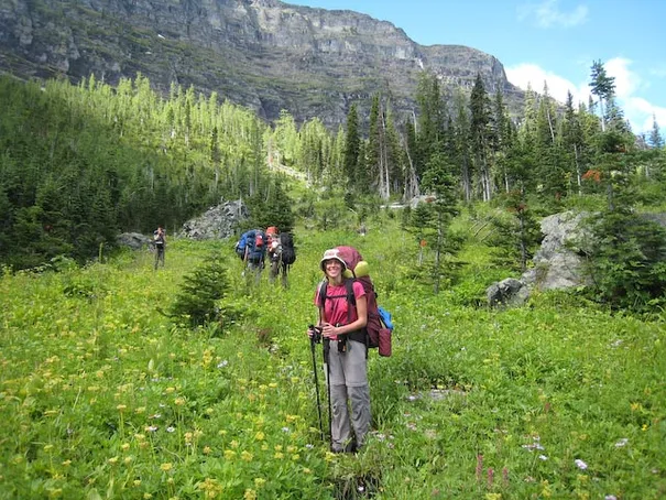 Robyn walking through a valley of beautiful wild flowers