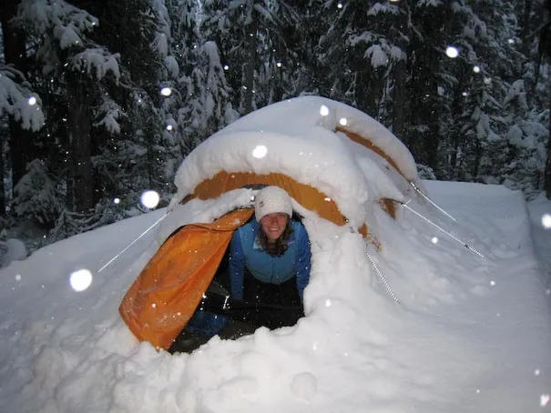 Robyn getting out of the tent in the morning after a 30cm dump overnight, Yoho National Park
