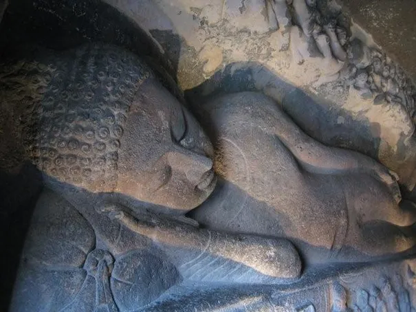 A reclining Budha carved into the walls at the Ajanta Caves.