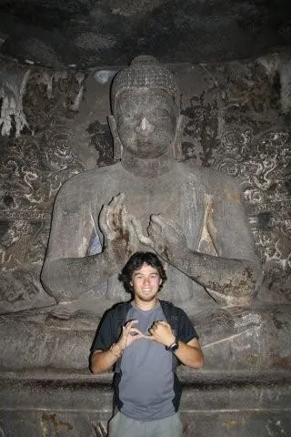 Glen praying with Budha, Ajanta Caves.